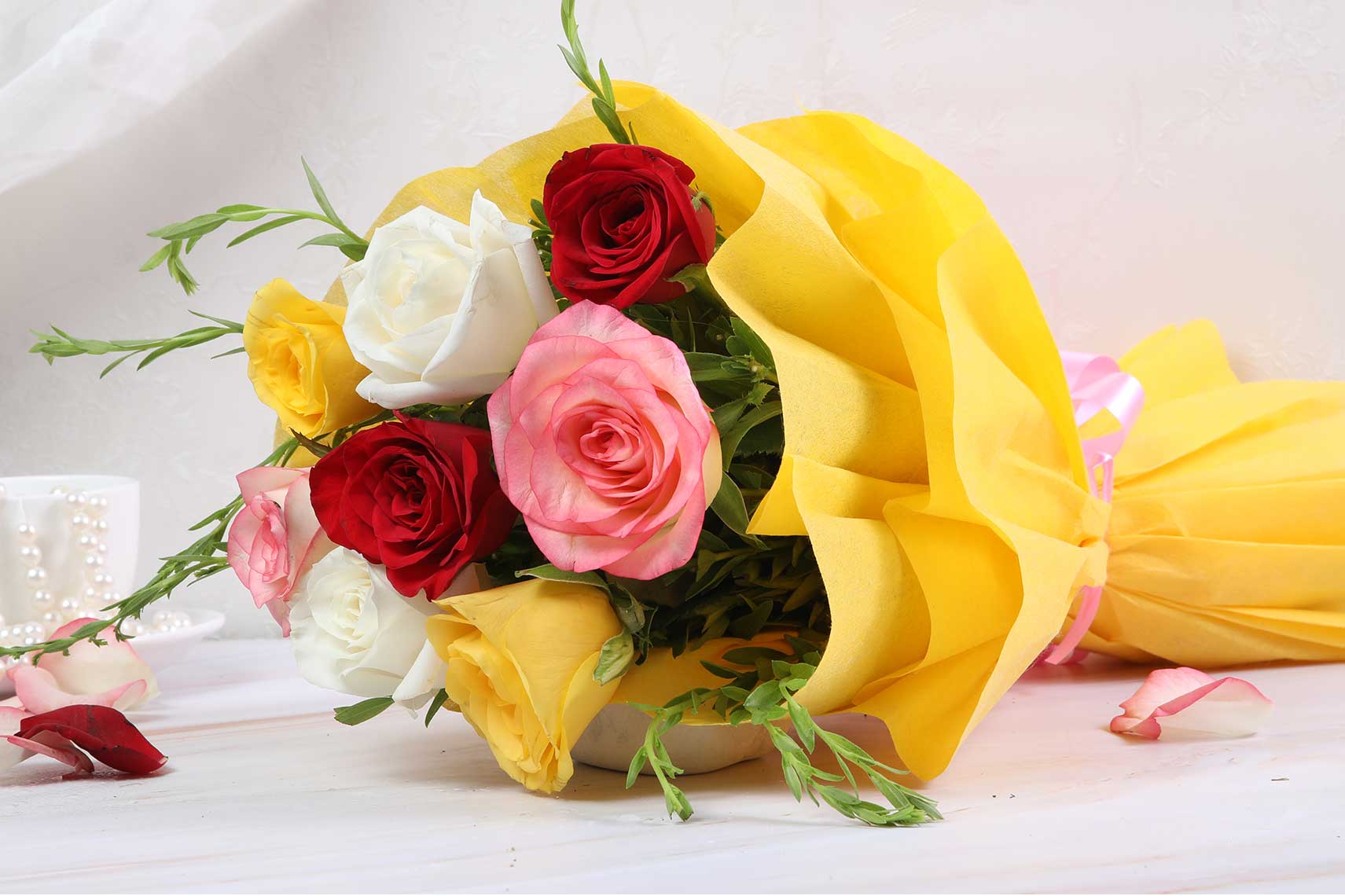 Eight rose bouquet with yellow wrapping