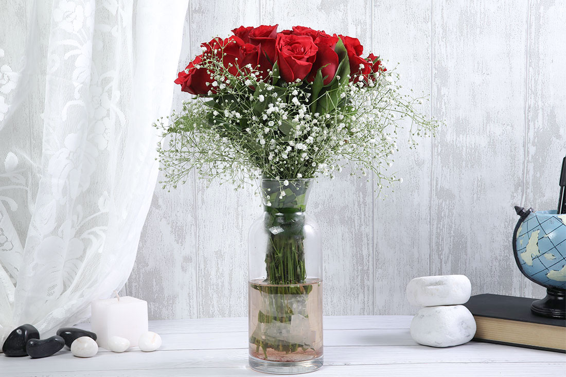Flower Arrangement of 24 Red Roses in a Glass Vase Send Now