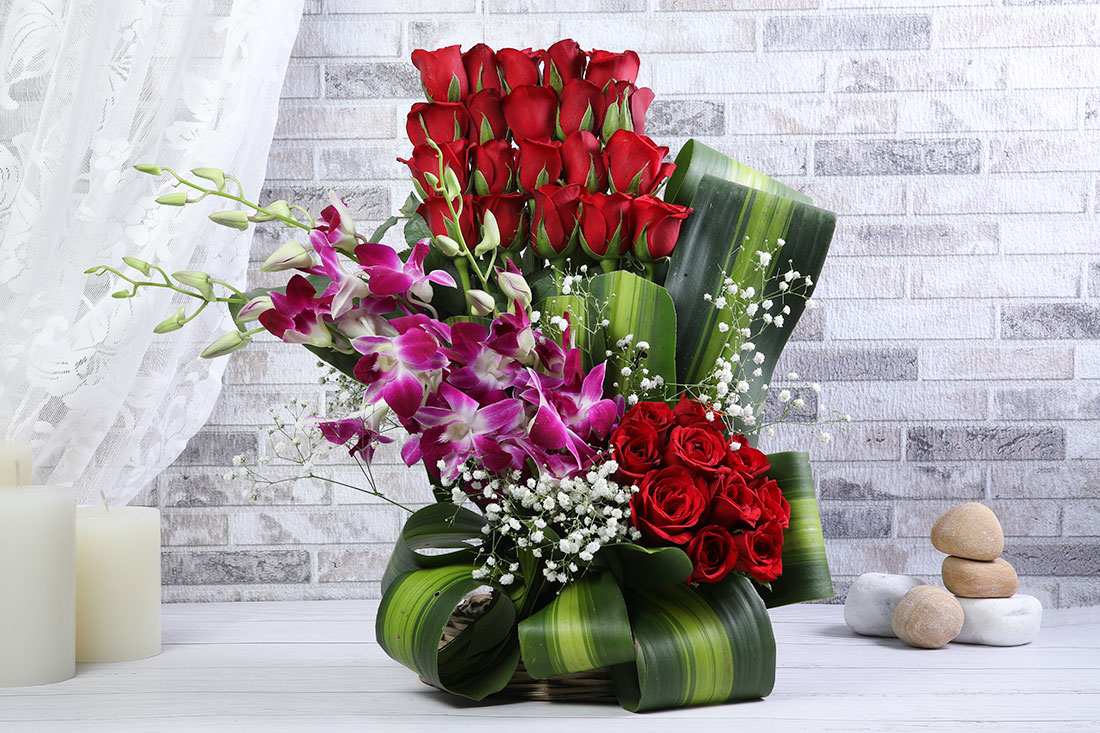 Arrangement of 30 Red Roses & 4 Blue Orchids in a Basket Buy Online