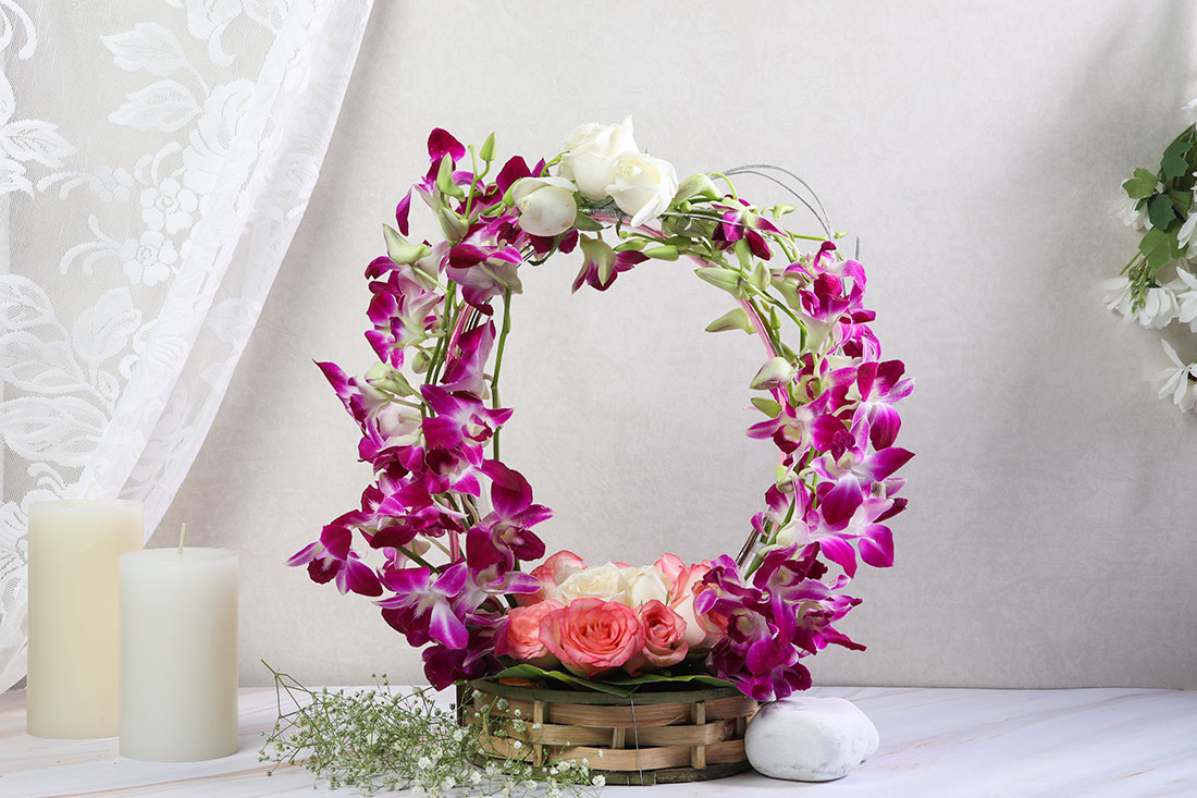 Beautiful Arrangement of 6 Pink Roses, 6 White Roses, and 8 Purple Orchids in a basket