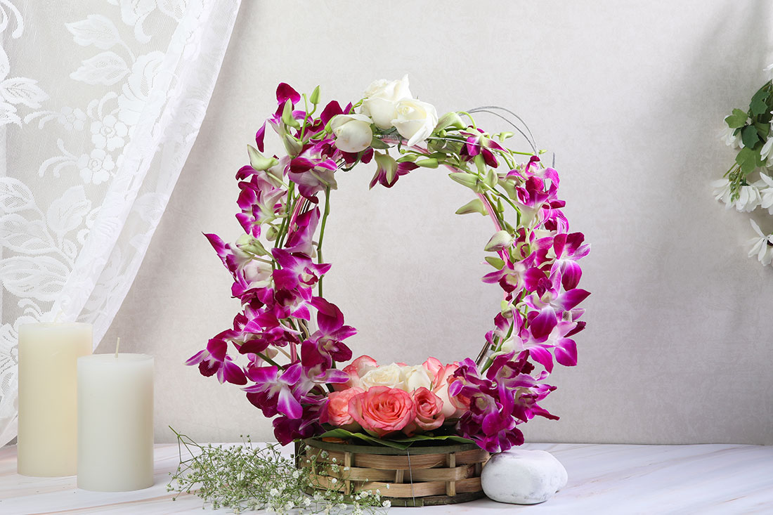 Beautiful Arrangement of 6 Pink Roses, 6 White Roses, and 8 Purple Orchids in a basket Delivery