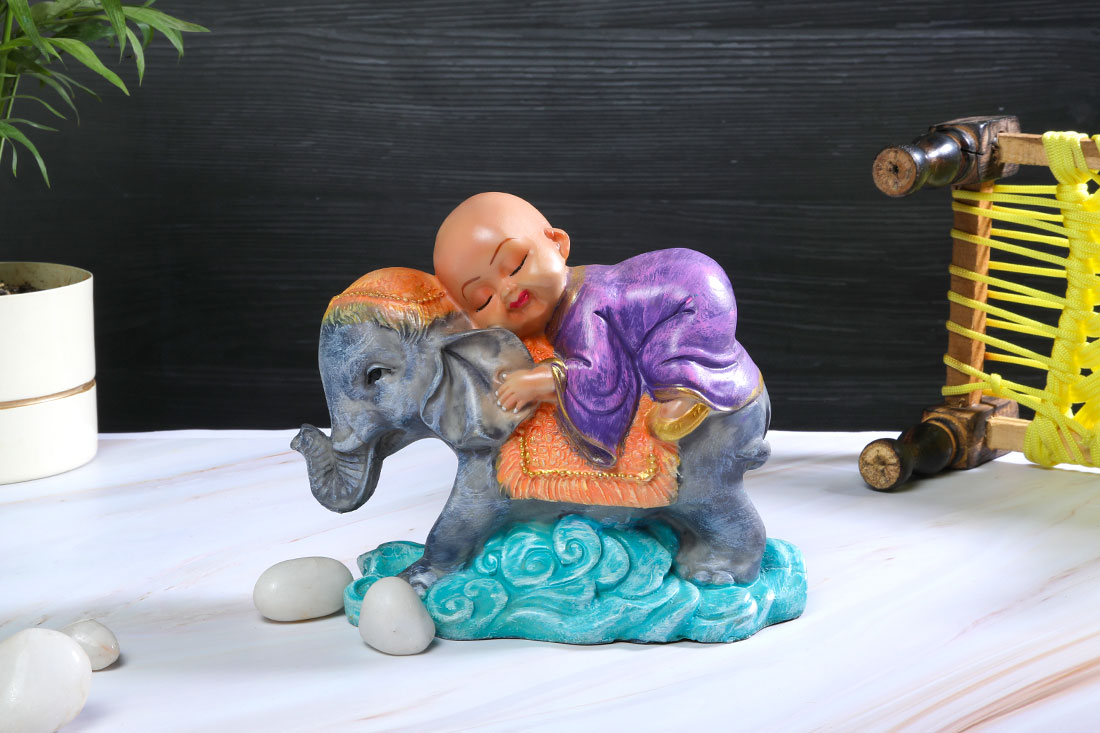 Order Baby monk resting on elephant Online
