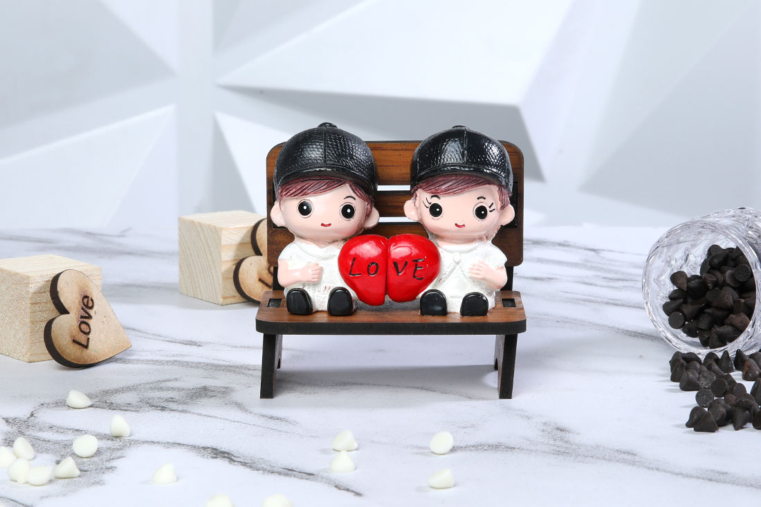 Couple holding heart miniature figurine