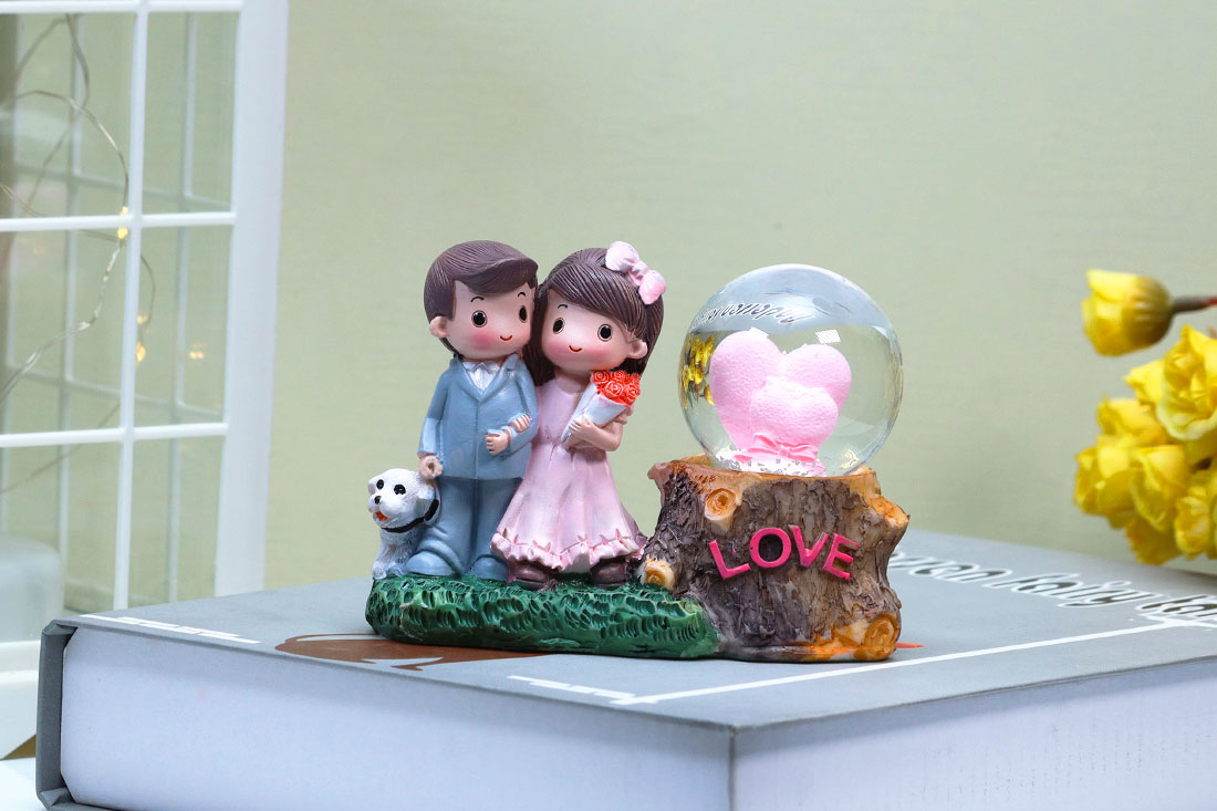 Adorable Married Couple with Snow Globe