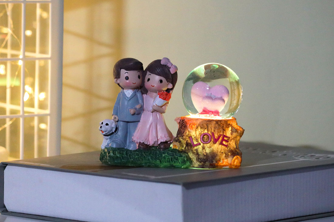 Adorable Married Couple with Snow Globe