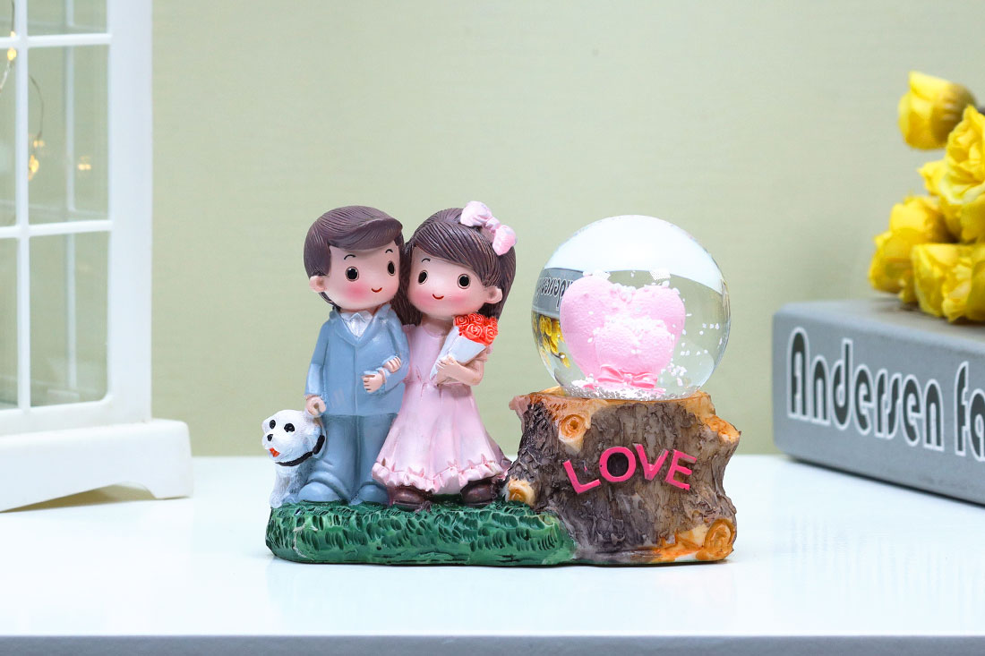 Adorable Married Couple with Snow Globe