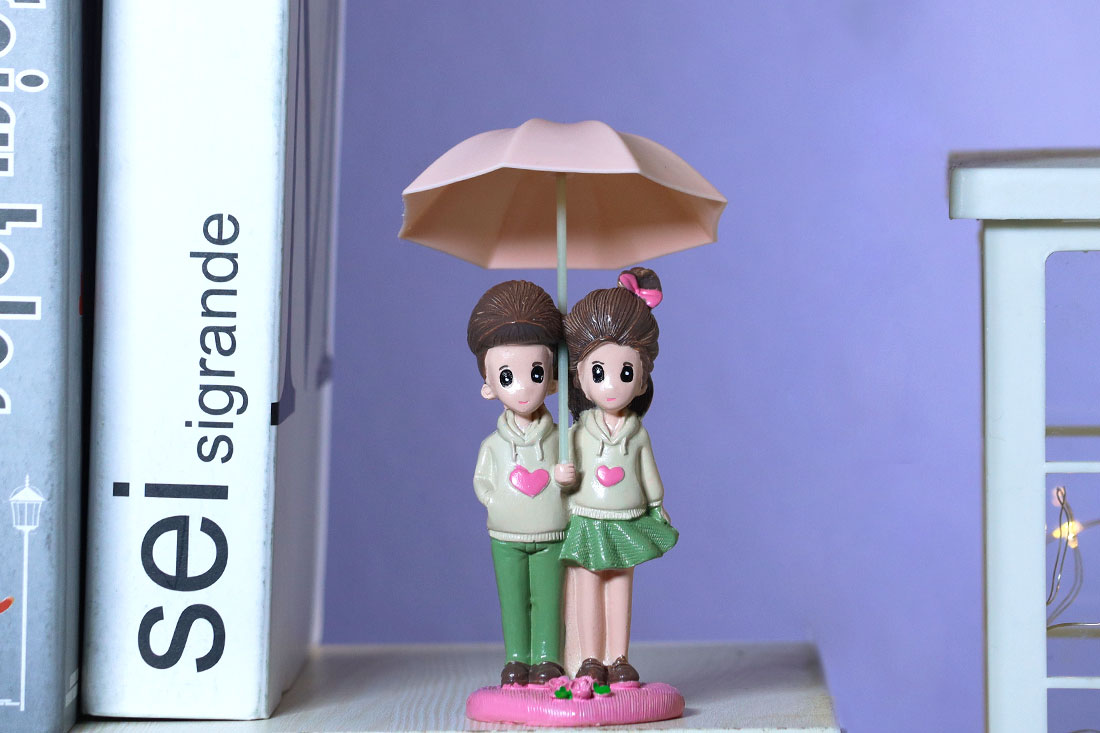 College Couple Under Umbrella