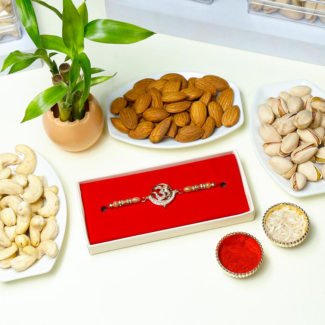 Send AD Om Rakhi With Dry Fruits N Lucky Bamboo Online