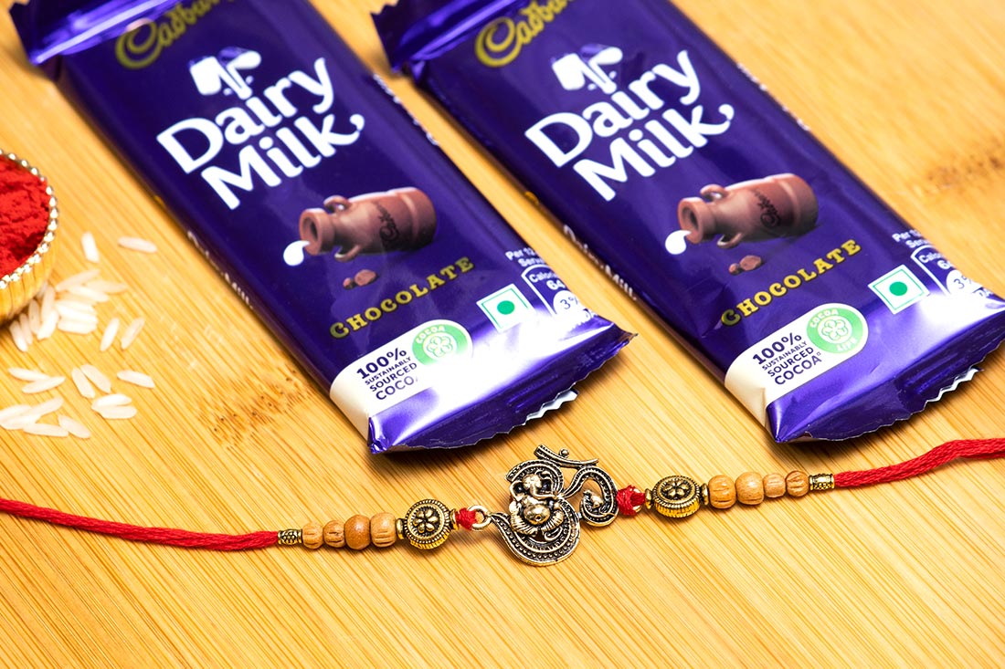 Beaded Om Rakhi With Dairy Milk Ecstasy