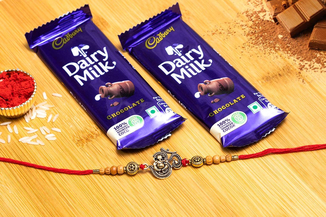 Order Beaded Om Rakhi With Dairy Milk Ecstasy Online