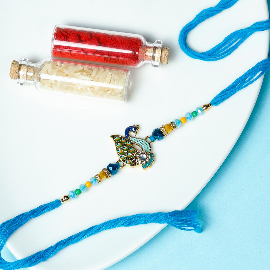 Beautiful Peacock Rakhi with Pista Barfi & Dragees