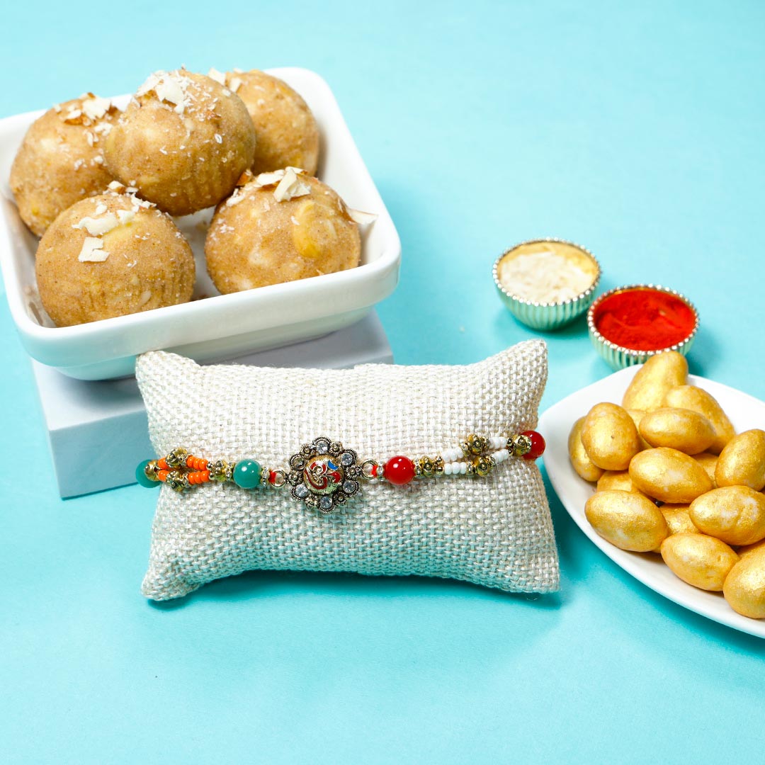 Order Designer OM Rakhi With Panjiri Ladoo N Almond Dragees