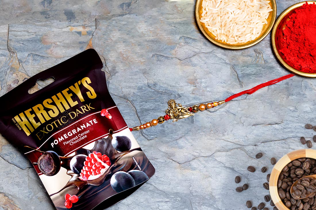 Golden Ganesha Rakhi With Hershey Delivery