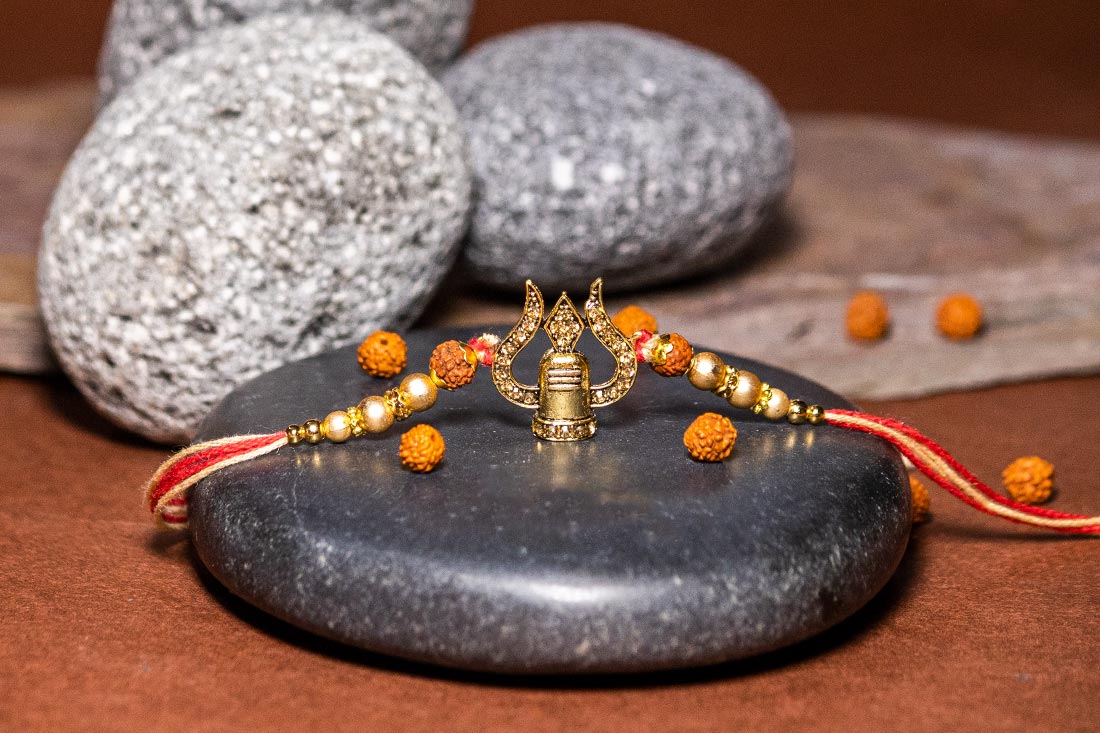 Golden trishul rakhi Online