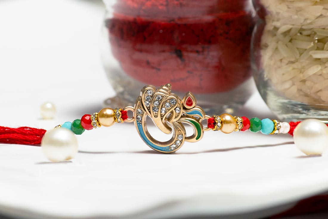 Silver embellished Om rakhi